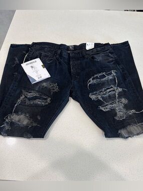 PRPS Goods & Co. distressed dark wash denim jeans.